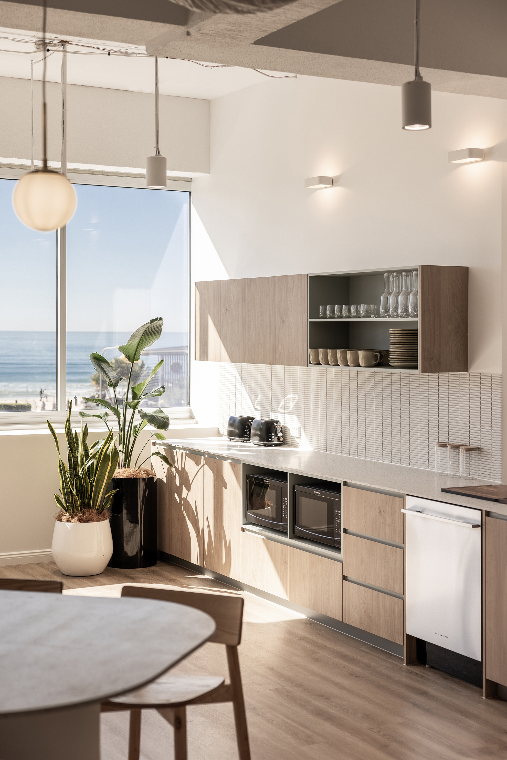 office kitchen with light wood cabinets